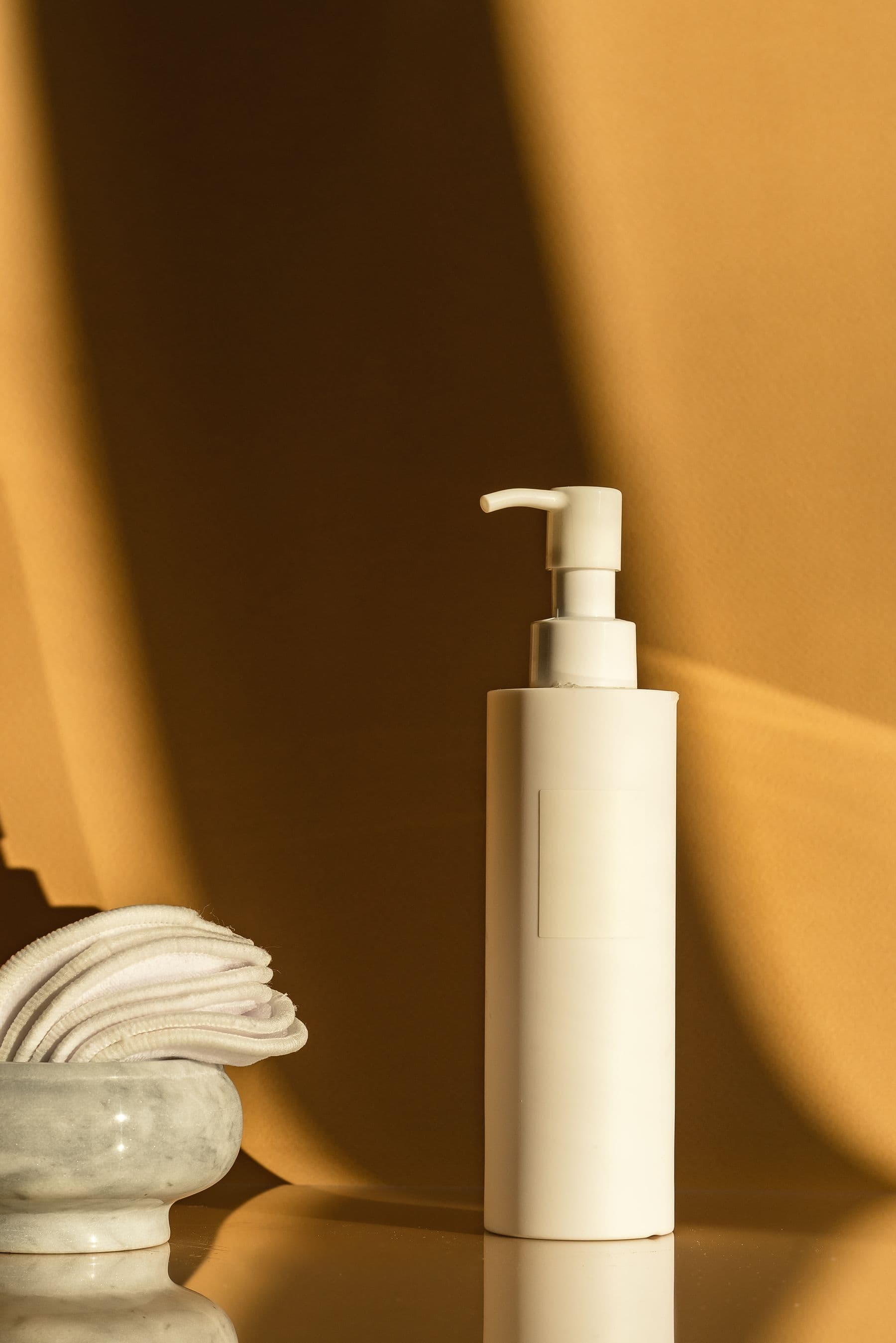 White cosmetic pump bottle in warm light